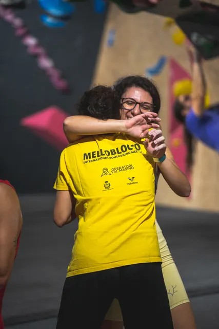 Two people hugging in the gym.