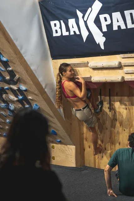 A climber hanging in a kneebar at the Black Pad station.